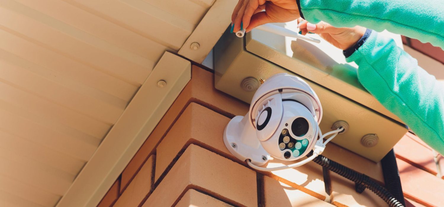 technician female setup cctv camera on wall