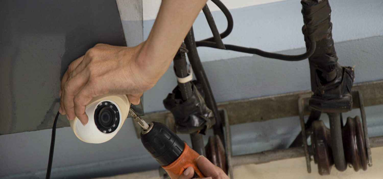 Man installing IP CCTV or high tech surveillance system CCTV system