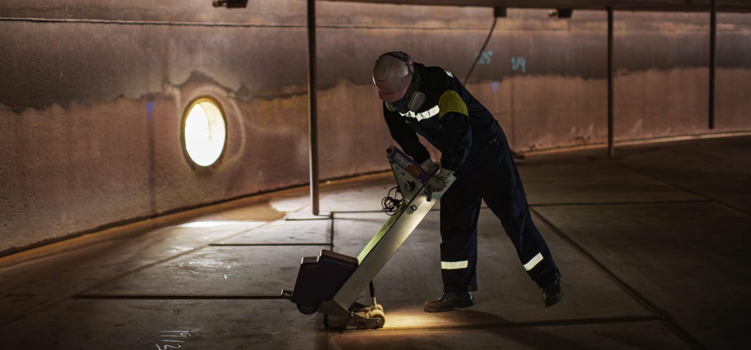 Male worker inspection floor scan tank external floating of rust  wall lose thickness bottom plate in manhole tank to work inside confined